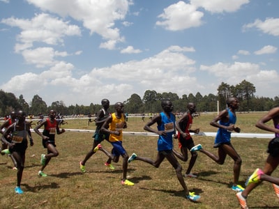 A group of people running in the playground
